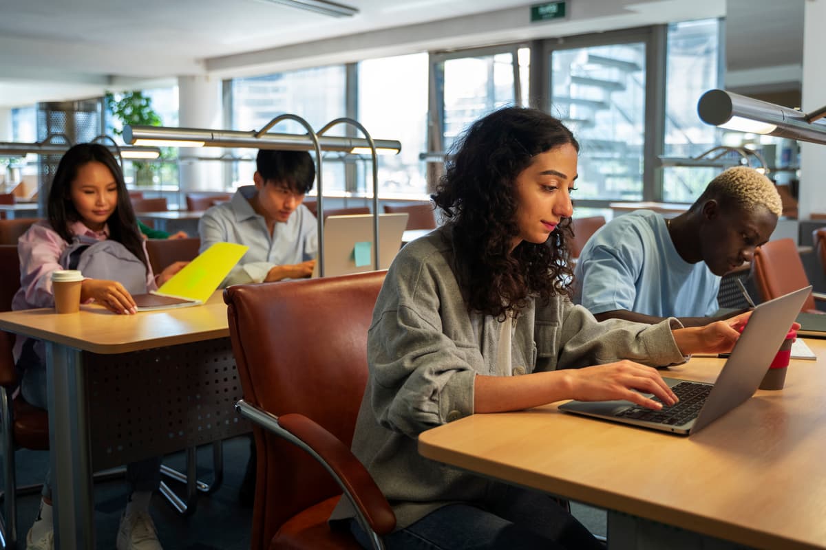 Teens collaborating with laptop